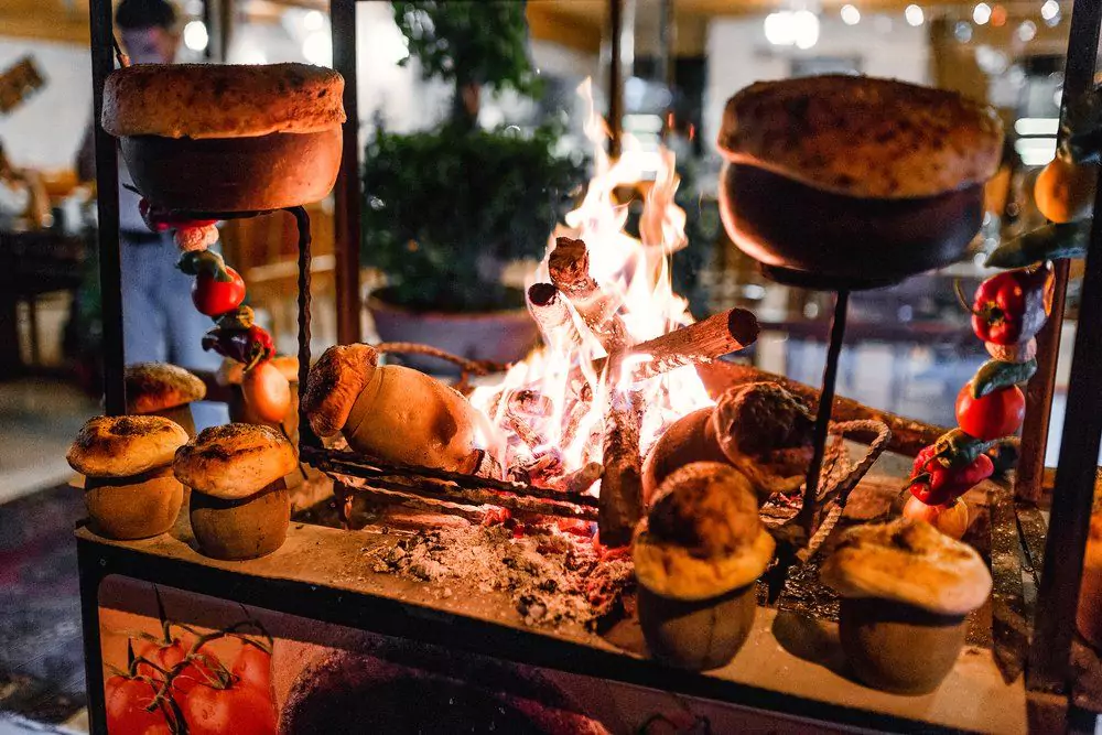 15 Fun Things to Do in Cappadocia, Turkey 14 unique things to do in cappadocia | Traditional Turkish Testi Kebab cooked in clay pot on open fire at night in restaurant, authentic oriental cuisine