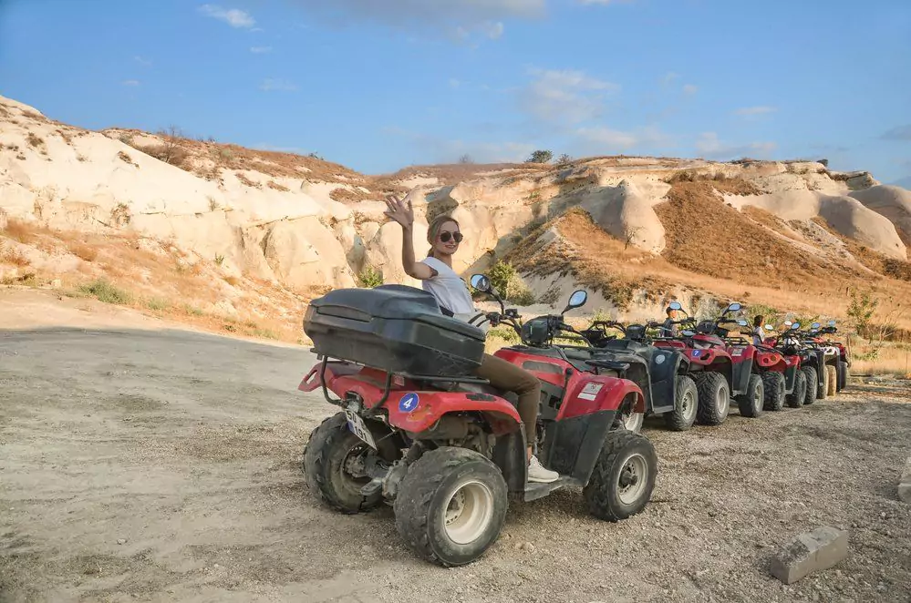 15 Fun Things to Do in Cappadocia, Turkey 12 Woman-on-quad-kappadocia.-ATV-Quad-Bike-in-front-of-mountains-landscape-in-Turkey