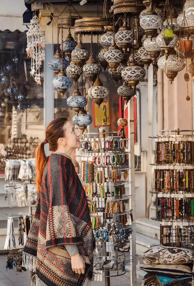 Where to Buy Souvenirs in Istanbul: Traveler woman enjoying traditional turkish light lamp decoration design