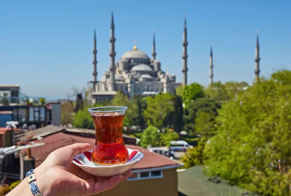 Traditional turkish tea in front of Blue mosque aka Sultanahmet Camii in Istanbul Turkey