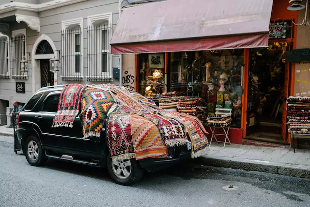 a picture shows carpets on the car in the street of istanbul